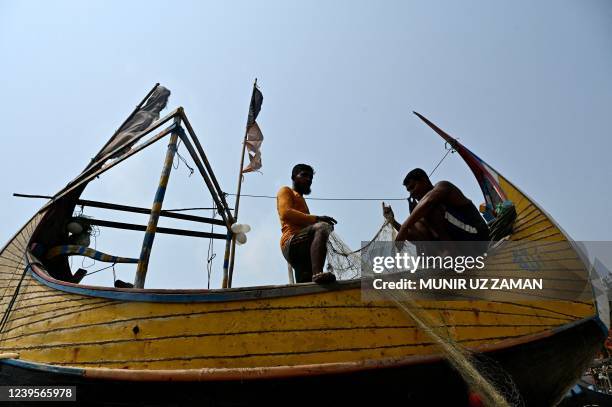 Fishermen prepare their net after fishing in the Bay of Bengal in Teknaf on March 28, 2022.