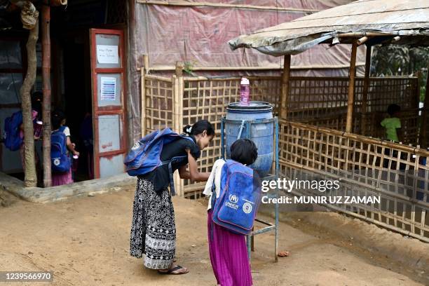 In this picture taken on March 27 Rohingya refugee children collect drinking water in a school in Kutupalong refugee camp in Ukhia. - Bangladesh has...