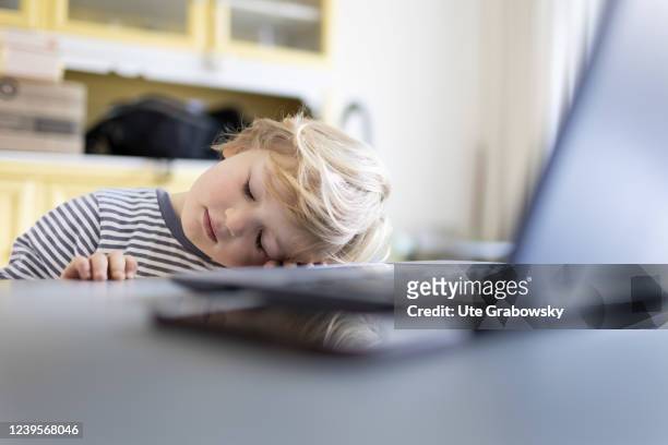 In this photo illustration Child is sleeping in front of a laptop on March 20, 2022 in Bonn, Germany.