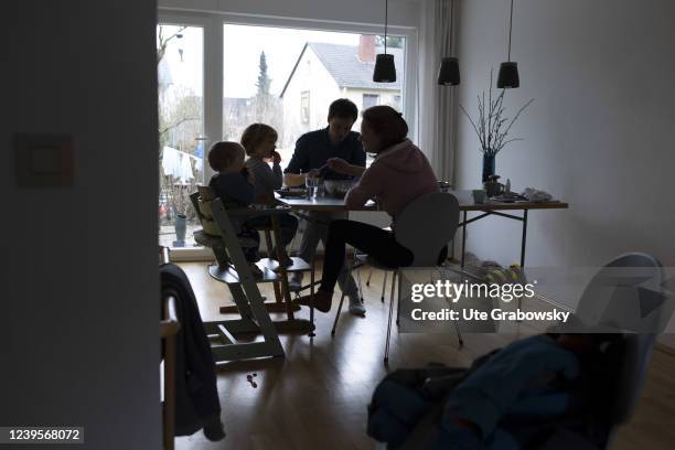 In this photo illustration a anonym family is sitting at a dining table on March 20, 2022 in Bonn, Germany.