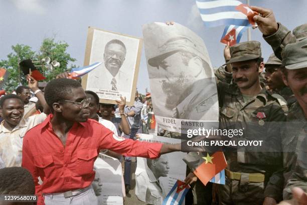 Cuban soldiers, who will leave soon Angola, show a poster at the effigy of Fidel Castro on January 9, 1989 during a ceremony held at the Cuban...