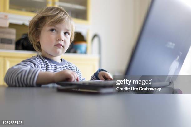In this photo illustration Child playing at a laptop on March 20, 2022 in Bonn, Germany.