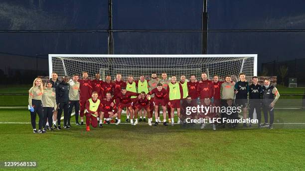 Liverpool Legends pose for a group photo with coaches and medical staff at AXA Training Centre on March 25, 2022 in Kirkby, England.