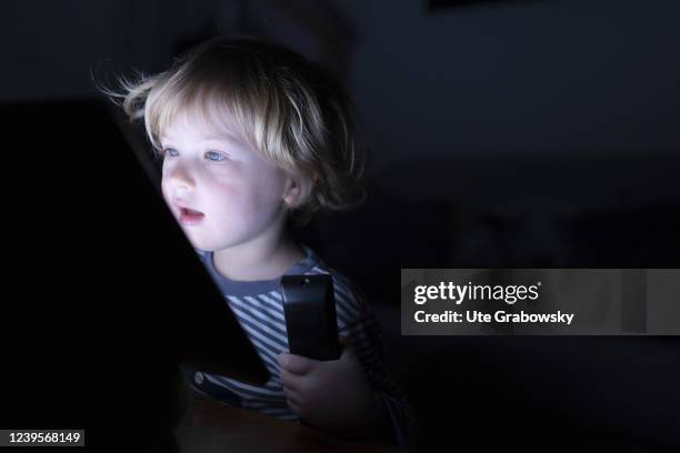 In this photo illustration a child is having a blueface from a screen on March 20, 2022 in Bonn, Germany.