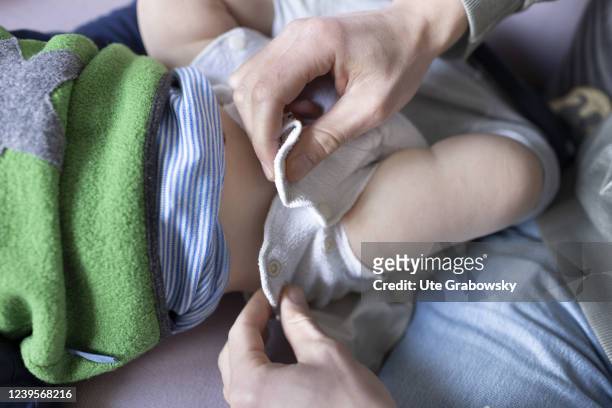 In this photo illustration a cloth diaper is fixed on a babys hip on March 20, 2022 in Bonn, Germany.