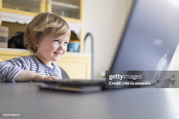 In this photo illustration Child playing at a laptop on March 20, 2022 in Bonn, Germany.