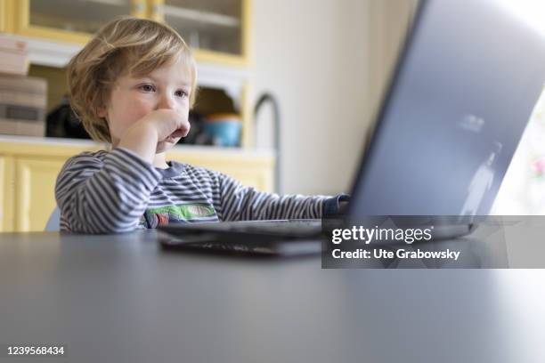 In this photo illustration Child playing at a laptop on March 20, 2022 in Bonn, Germany.