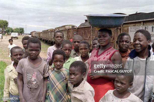 Angolan youth pose at Cunjo train station, central Angola, on January 13, 1989. The railway, linking Angola to Mozambique, is the longest one in...