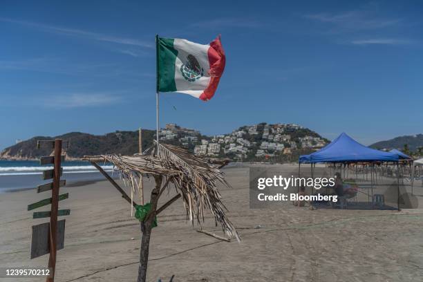 Mexican flag at a beach in Acapulco, Guerrero state, Mexico, on Friday, March 25, 2022. Although Mexico briefly added Covid-19 restrictions in early...