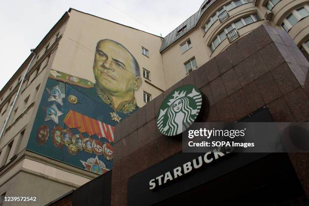 Starbucks sign is seen alongside the mural of Georgy Zhukov, a Soviet general and Marshal of the Soviet Union who oversaw some of the USSRâs most...