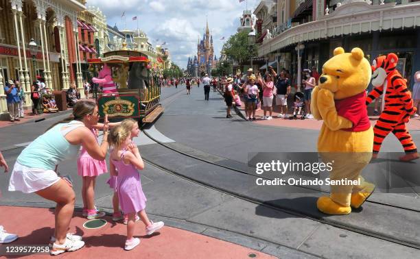 Young guests enjoy seeing Winnie The Pooh, and Tigger too, at the Magic Kingdom at Walt Disney World, in Lake Buena Vista, Florida, on May 17 after...