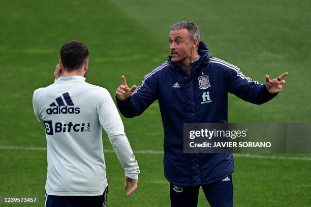 Spain's coach Luis Enrique speaks with Spain's defender Dani Carvajal during a training session in La Coruna on March 28 on the eve of the friendly...