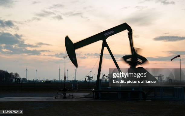 March 2022, Lower Saxony, Emlichheim: Deep pumps for oil demand stand in a field at sunset. Photo: Lino Mirgeler/dpa