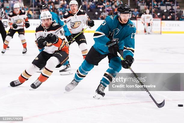 San Jose Sharks center Nick Bonino carries the puck away from Anaheim Ducks center Dominik Simon during the NHL game between the San Jose Sharks and...