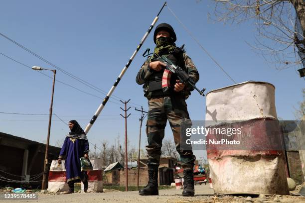 An Indian Army soldier stands alert at a check point in South Kashmir's Kulgam District, Jammu and Kashmir, India on 28 March 2022.