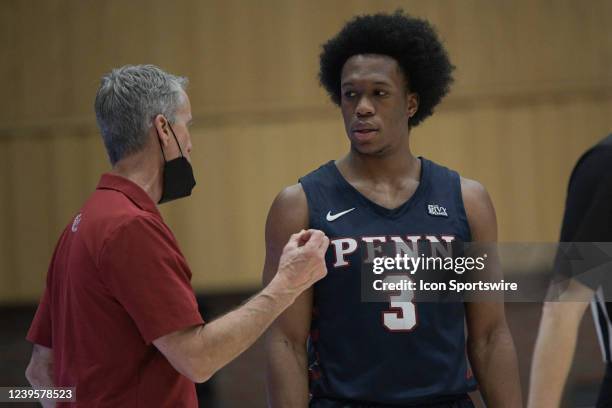 Pennsylvania Quakers guard Jordan Dingle receives feedback from head coach Steve Donahue during a break in action during the semifinal college...