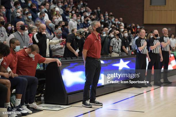 Pennsylvania Quakers head coach Steve Donahue stands during the singing of the national anthem prior to the semifinal college basketball game of the...