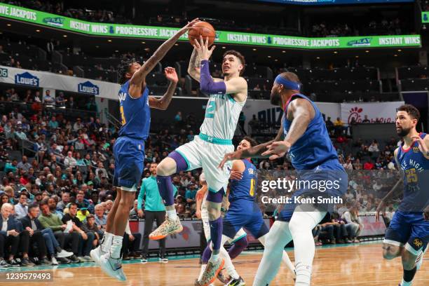 LaMelo Ball of the Charlotte Hornets drives to the basket during the game against the Denver Nuggets on March 28, 2022 at Spectrum Center in...