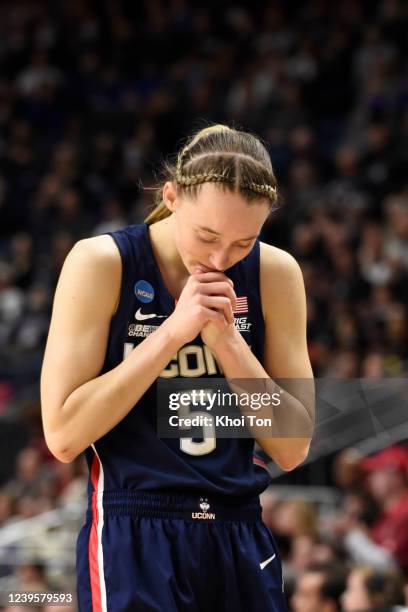 Paige Bueckers of the Connecticut Huskies reacts to an injury to teammate Dorka Juhasz during play against the N.C. State Wolfpack in the Elite Eight...