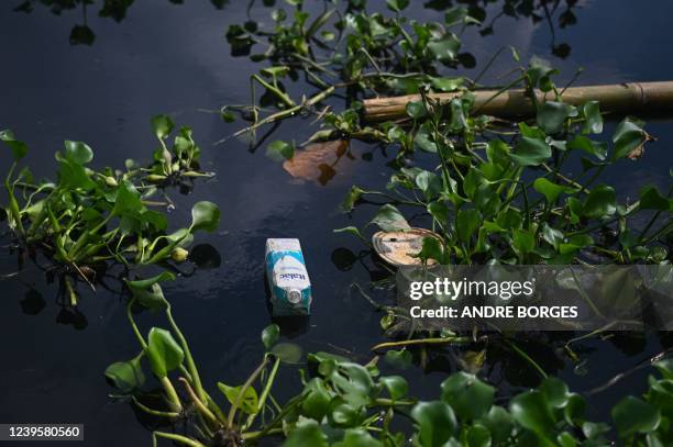 Picture of recyclable trash seen in a river that flows into Guanabara Bay, in Rio de Janeiro, Brazil, on March 20, 2022. - Situated at the heart of...