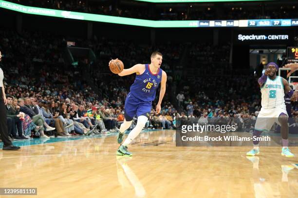 Nikola Jokic of the Denver Nuggets dribbles the ball during the game against the Charlotte Hornets on March 28, 2022 at Spectrum Center in Charlotte,...