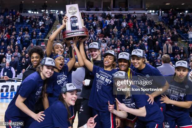 UConn Huskies pose for pictures after defeating the NC State Wolfpack to become Regional Champions during the Elite Eight of the Women's Div I NCAA...