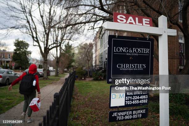 Child walks past a home for sale on G St. SE. The neighborhood of Hill East is between Capitol Hill and the Anacostia River and straddles the borders...