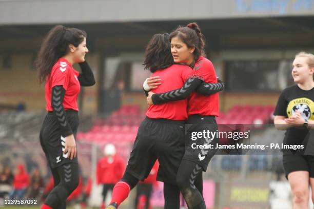 Elaha hugs a fellow player after scoring a goal during a match against the Women's Parliamentary Team at Dulwich Hamlet Football Club, south London....