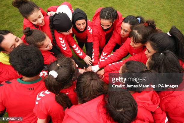 Players from the Afghanistan Development Squad put their hands together before kick off against the Women's Parliamentary Team at Dulwich Hamlet...