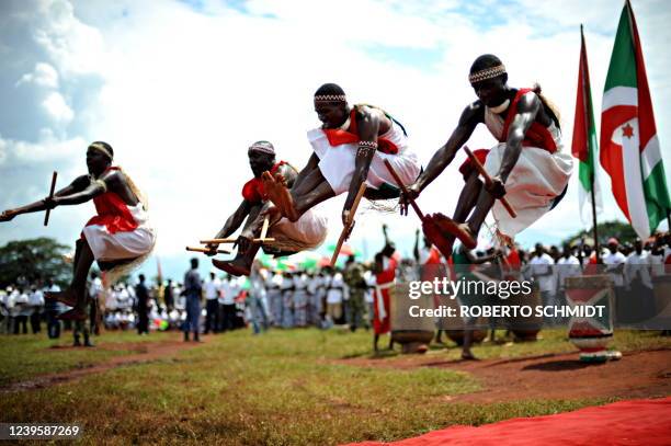 Burundi's Nkurunziza on God and grassroots development** Traditional Burundian drummers leap in the air during a political rally by Burundian...