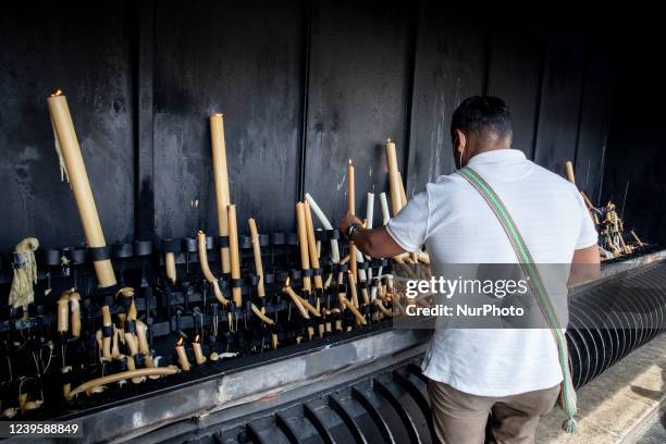 Man light a candle in the Sanctuary of Our Lady of Fátima, in Fatima, Portugal, on March 28, 2022.