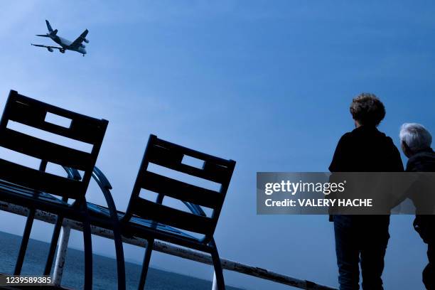 Members of the public look at an Airbus A380 flying along the "Promenade des Anglais" on the French riviera city of Nice during an airport test day,...