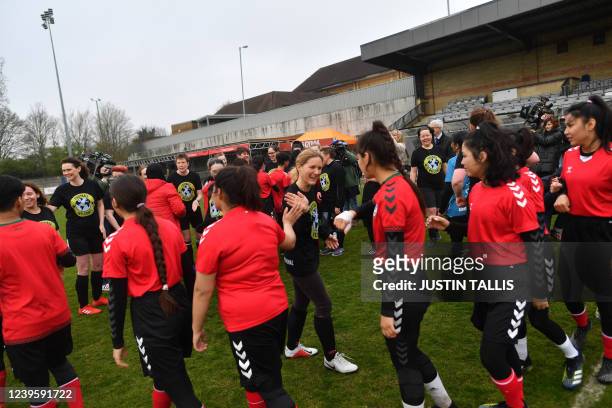 Womens parliamentary team players welcome Afghan development squad prior to the football match between Afghan development squad and Womens...