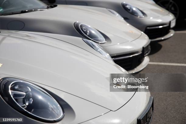 Porsche 911, left, a Porsche 911 Carrera 4S, center, and a Porsche 911 Carrera 4 automobile at a Porsche SE showroom in Berlin, Germany, on Tuesday,...