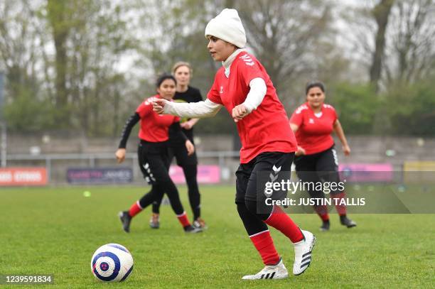 Afghan development squad team player controls the ball during the football match between Afghan development squad and Womens parliamentary team, at...