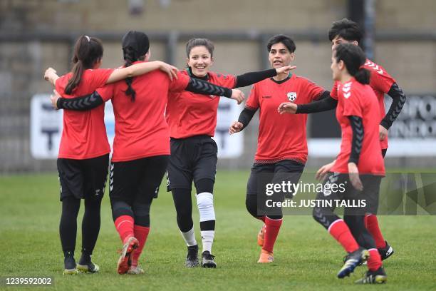 Afghan development squad team players celebrate after scoring during the football match between Afghan development squad and Womens parliamentary...