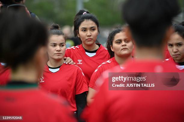 Afghan development squad team players gather at the end of the football match between Afghan development squad and Womens parliamentary team, at the...