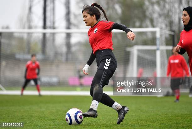 Afghan development squad team player controls the ball during the football match between Afghan development squad and Womens parliamentary team, at...