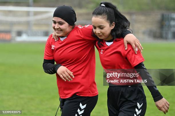 Afghan development squad team players leave the pitch at the end of the football match between Afghan development squad and Womens parliamentary...