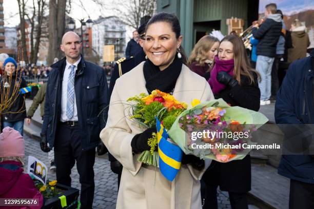 Crown Princess Victoria of Sweden stops to speak with a child during a public concert celebrating Norrtaljes 400th anniversary on March 29, 2022 in...