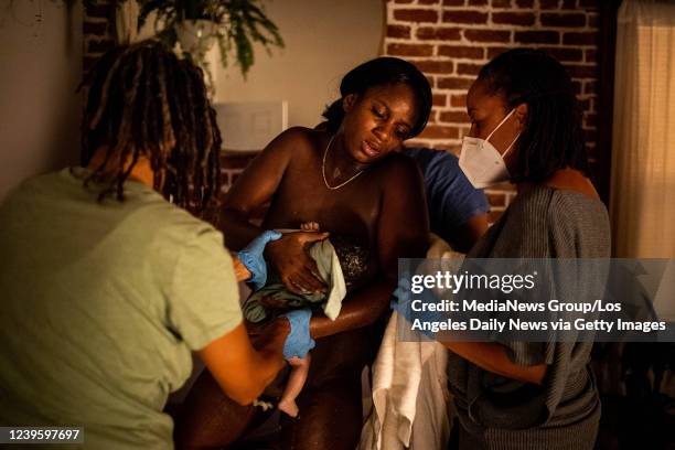 Midwives Kimberly Durdin and Allegra Hill help Aysha-Samon Stokes out of the birthing bath at Kindred Space LAs birthing center in South Los Angeles...