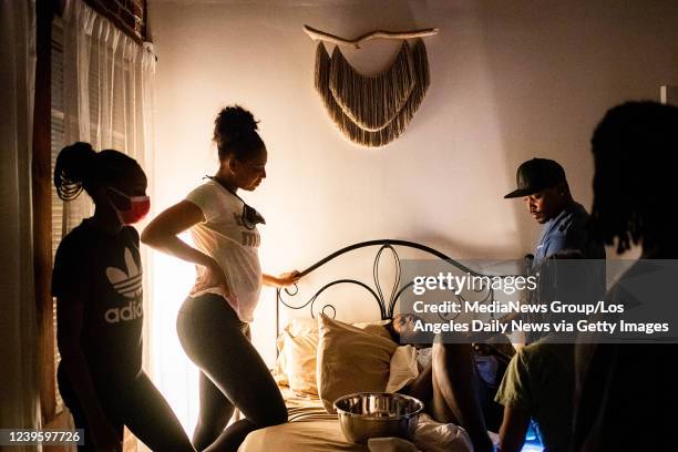 Aysha-Samon Stokes is watched over by her sister Lauri Powell and Powells 13-year-old daughter Leena and her partner Dennis Richmond after she...