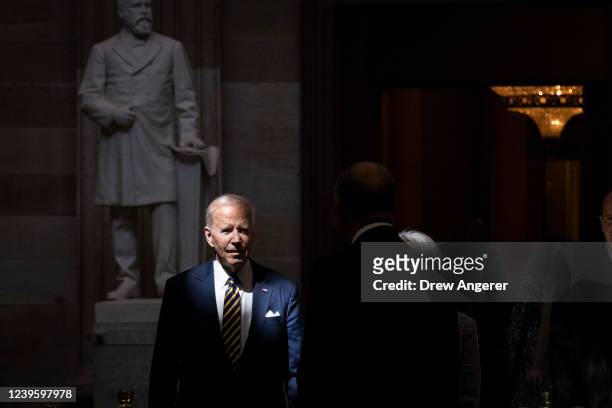 President Joe Biden walks through the Rotunda as he arrives to pay his respects to the late Rep. Don Young while lying in state in Statuary Hall at...