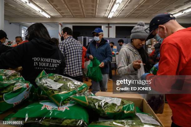 Staff and volunteers at the Hungry Monk food pantry prepare and distribute fruit and vegetables to local residents at their church in Queens, New...