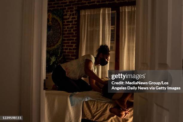 Lauri Powell massages her sister Aysha-Samon Stokes during labor at Kindred Space LAs birthing center in South Los Angeles on Mothers Day night, May...