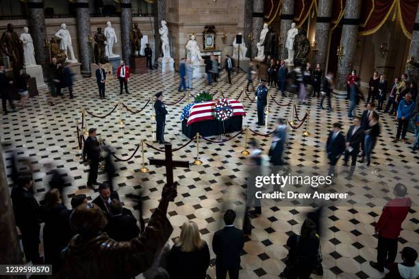 Visitors file past a flag-draped casket of Rep. Don Young as he lies in state in Statuary Hall at the U.S. Capitol March 29, 2022 in Washington, DC....