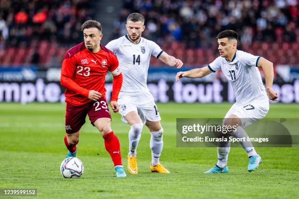 Xherdan Shaqiri of Switzerland against Valon Berisha of Kosovo and Florian Loshaj of Kosovo during the international friendly match between...