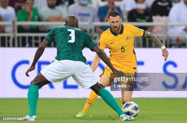 Australia's forward Martin Boyle vies for the ball with Saudi Arabia's defender Abdullah Madu during the 2022 Qatar World Cup Asian Qualifiers...