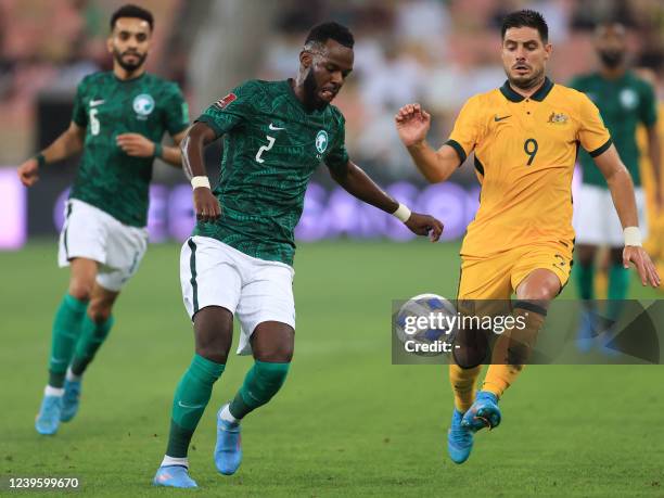 Saudi Arabia's defender Hassan Tambakti vies for the ball with Australia's forward Jamie Maclaren during the 2022 Qatar World Cup Asian Qualifiers...