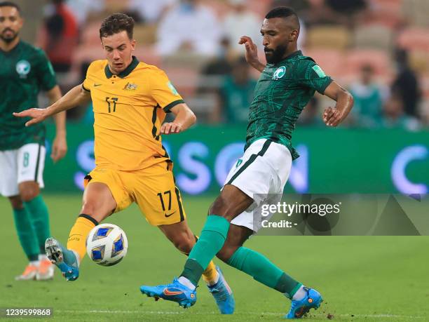 Australia's midfielder Denis Genreau vies for the ball with Saudi Arabia's midfielder Khalid al-Ghannam during the 2022 Qatar World Cup Asian...